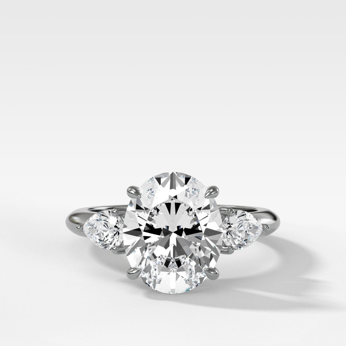 Three Stone Engagement Ring With Pear Side Stones and Oval Cut Diamond - GOODSTONE