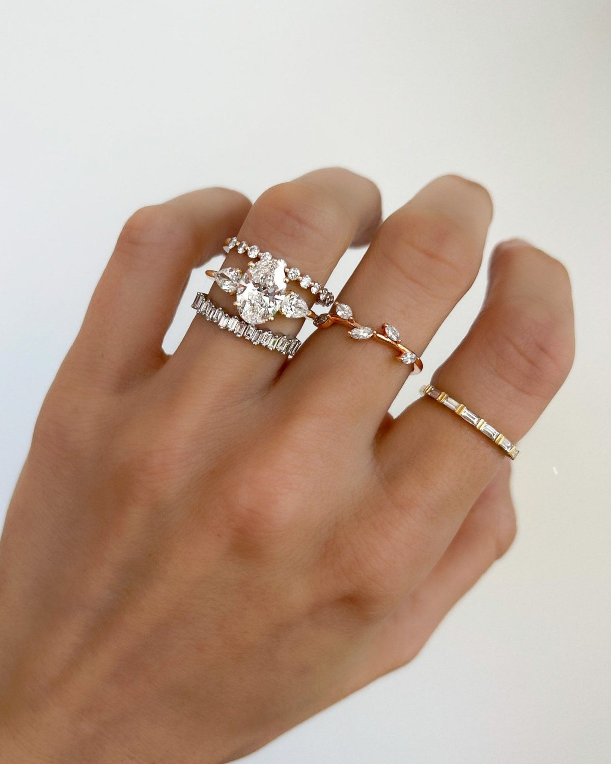 Three Stone Engagement Ring With Pear Side Stones and Oval Cut Diamond - GOODSTONE