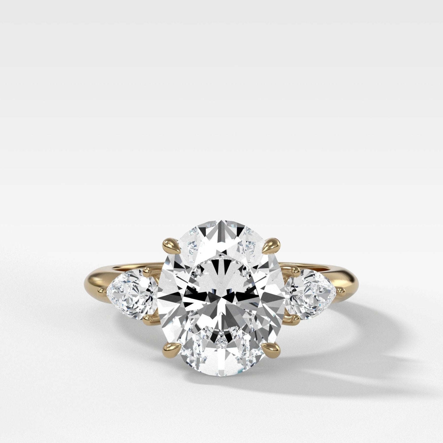 Three Stone Engagement Ring With Pear Side Stones and Oval Cut Diamond - GOODSTONE