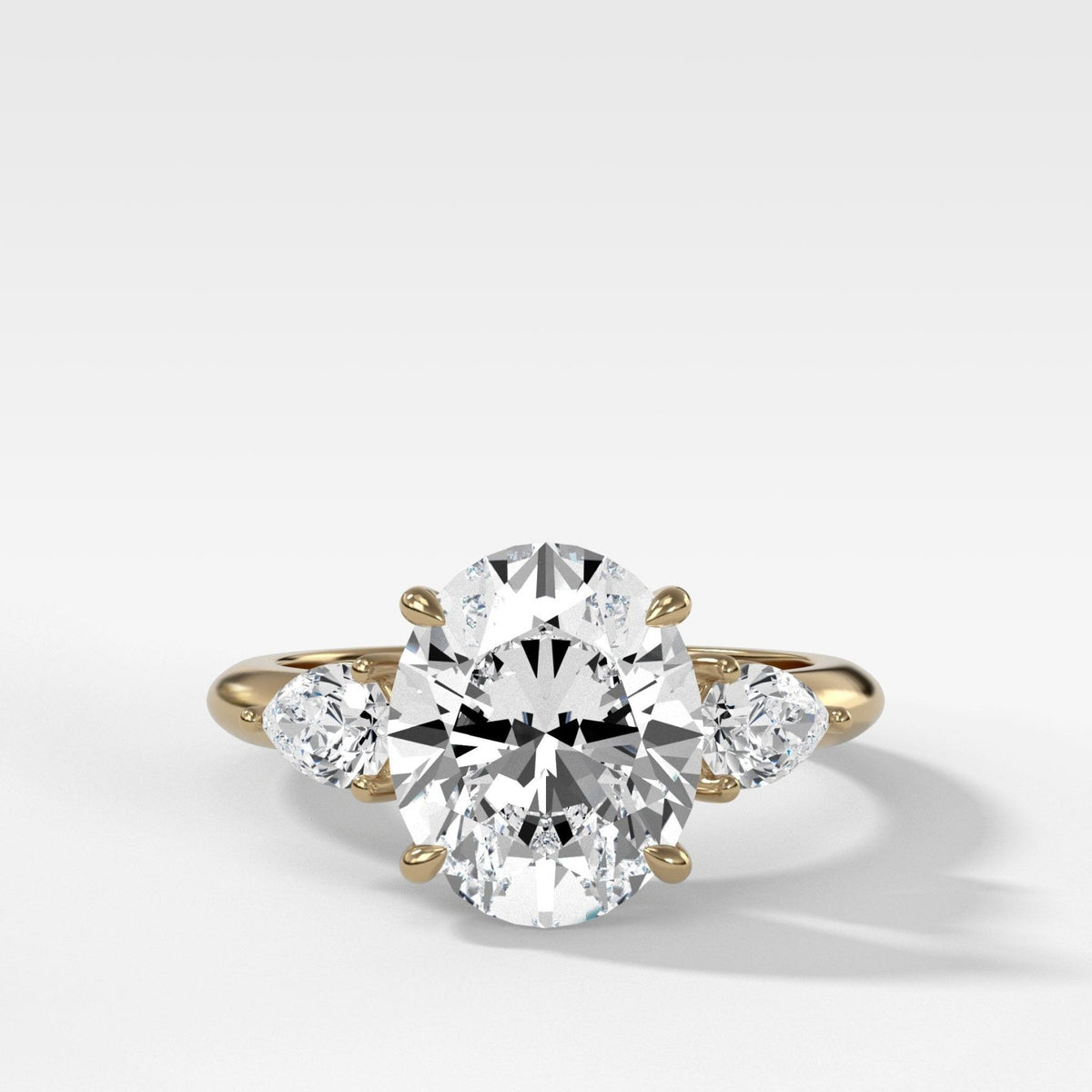 Three Stone Engagement Ring With Pear Side Stones and Oval Cut Diamond - GOODSTONE