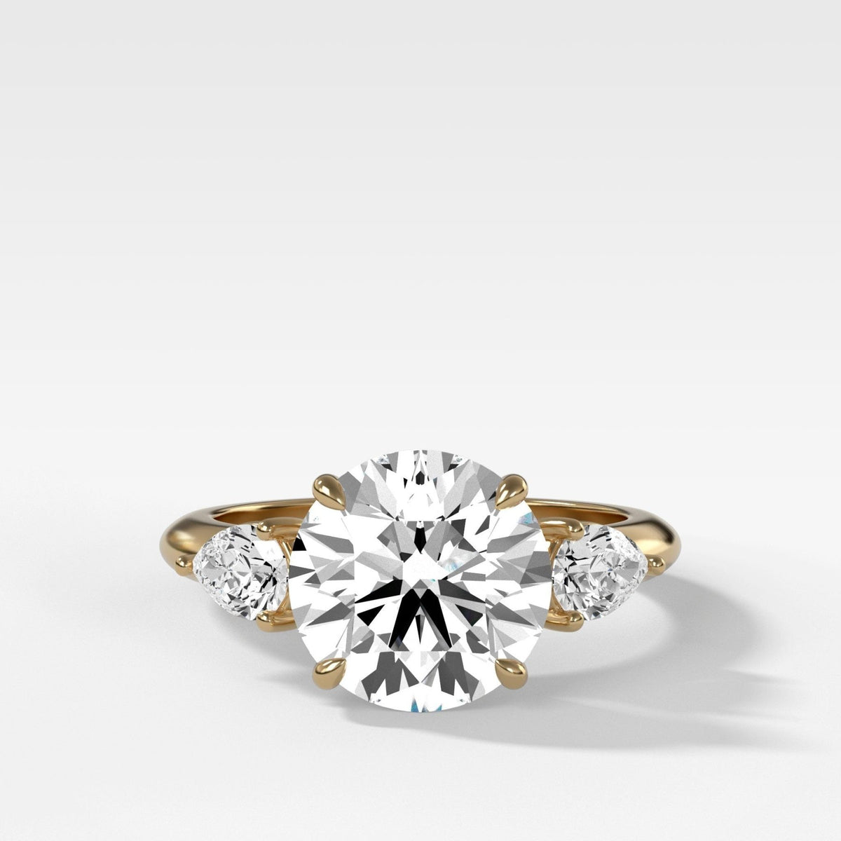 Three Stone Engagement Ring With Pear Side Stones With Round Cut Diamond